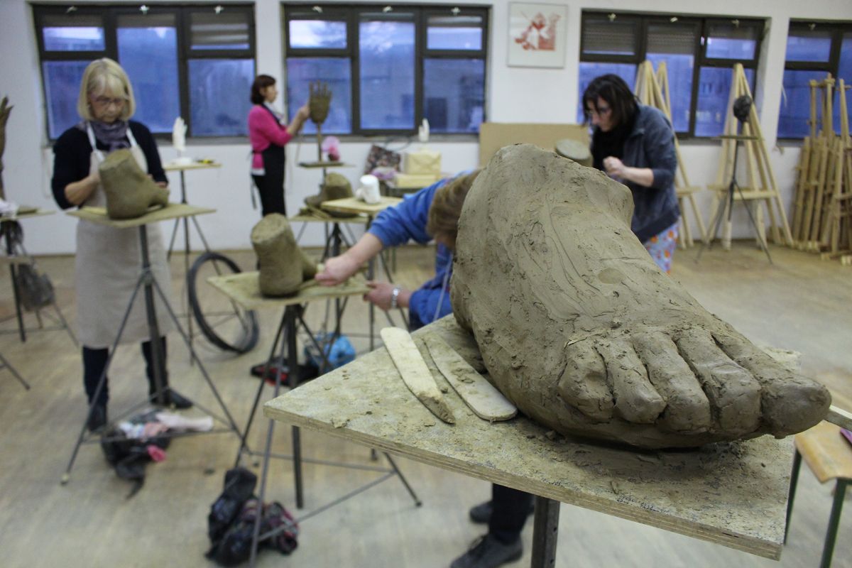 Modeling a foot in clay.