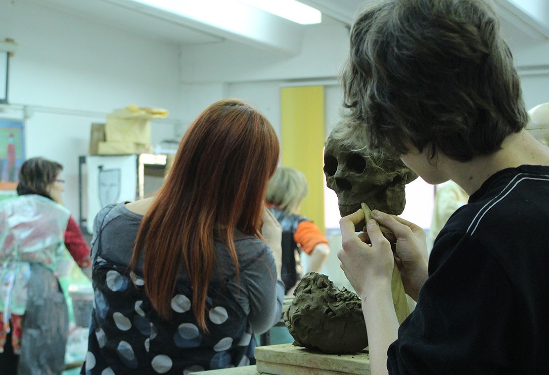 Modeling a skull in clay.