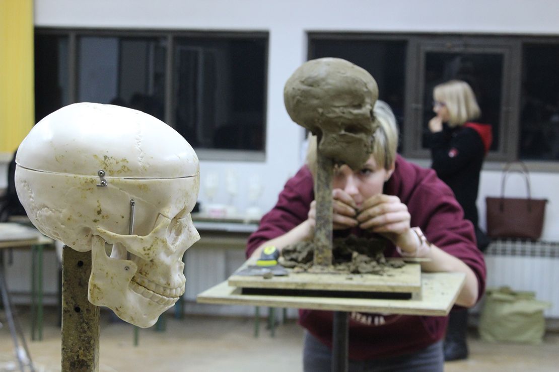 Modeling a skull in clay.