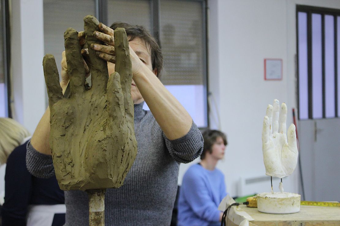 Modeling a hand in clay.