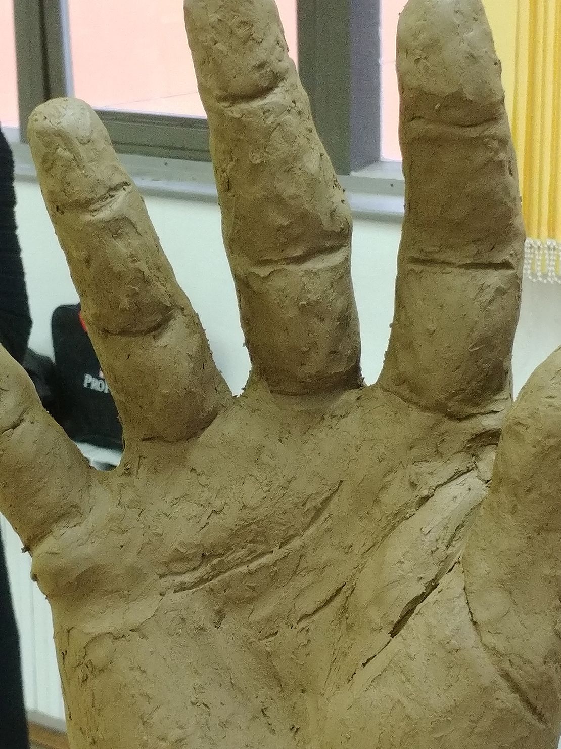 Modeling a hand in clay.