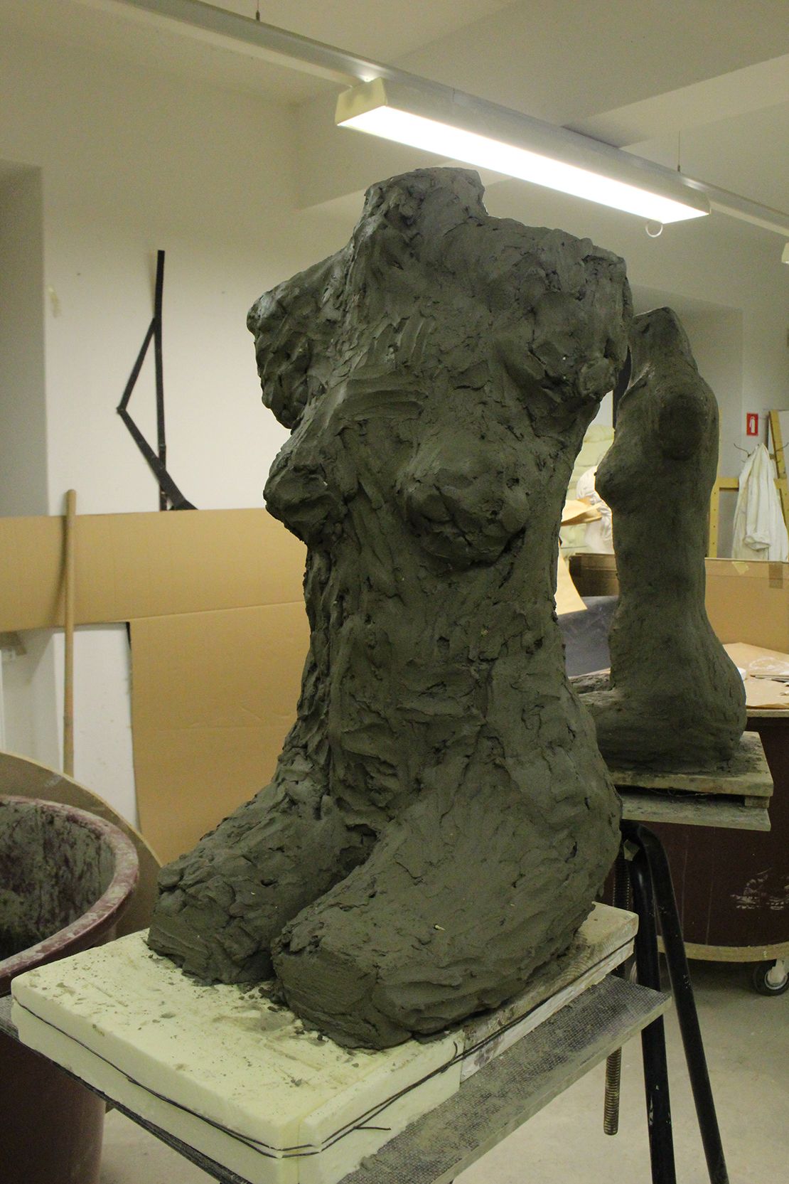 Modeling a torso in clay.