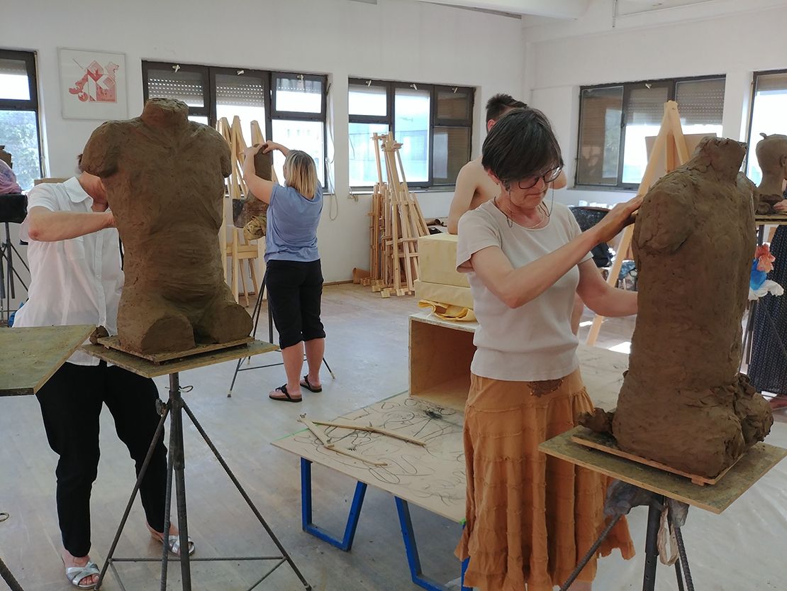 Modeling a torso in clay.