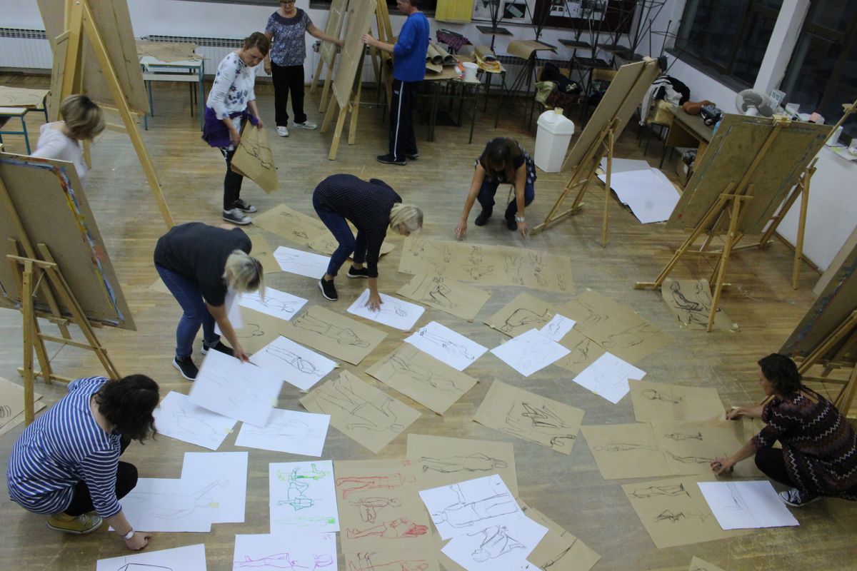 Tens of sketches spread on the studio floor.