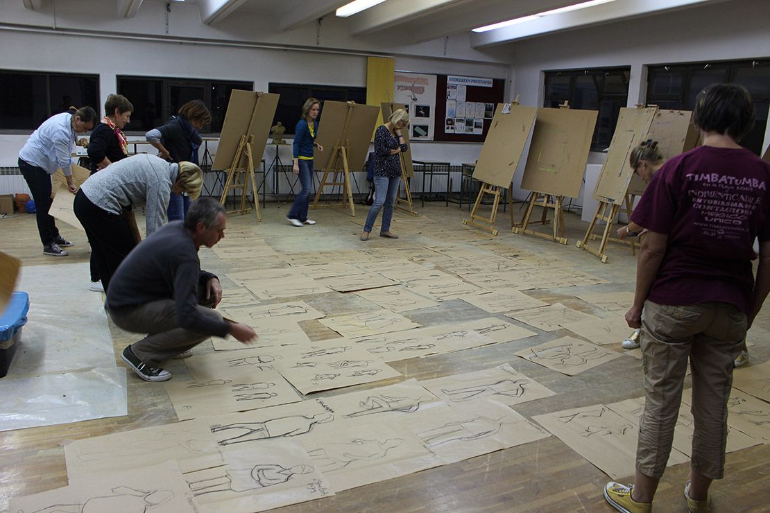 Tens of sketches spread on the studio floor.