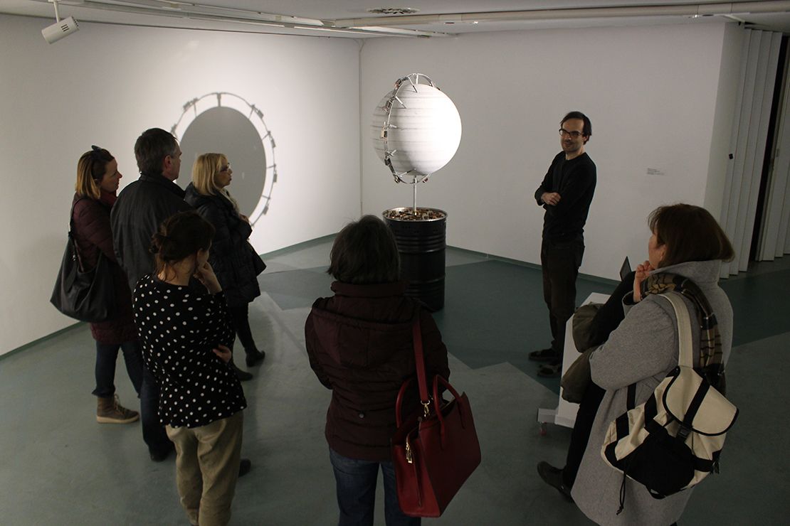 Discussing artwork on an exhibition.