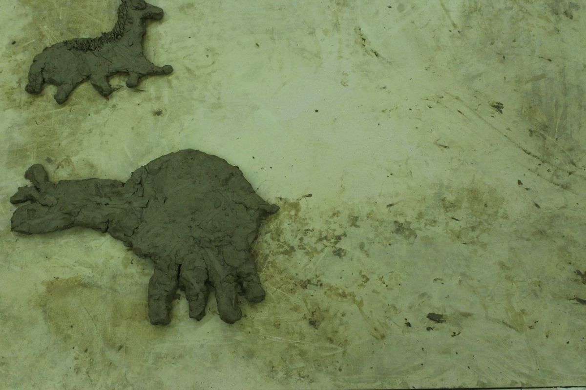 Animals of Prehistory in clay relief.