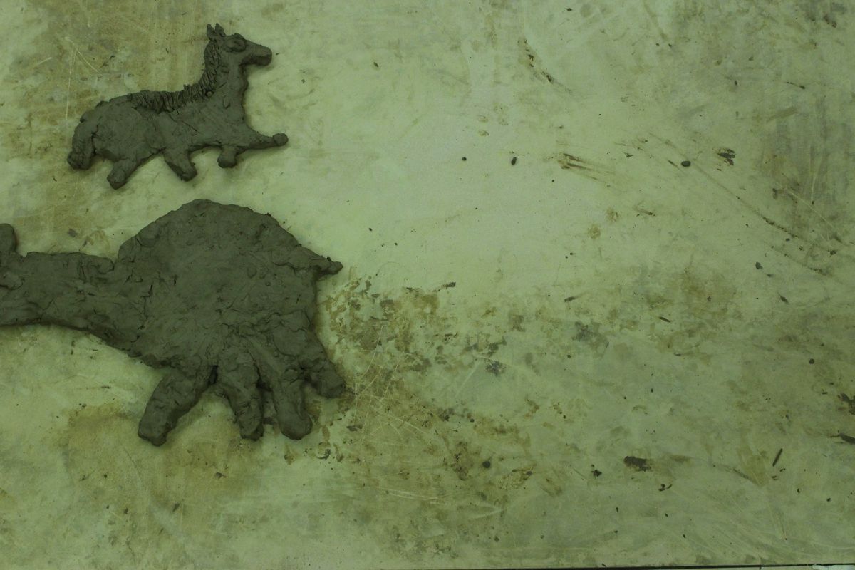 Animals of Prehistory in clay relief.