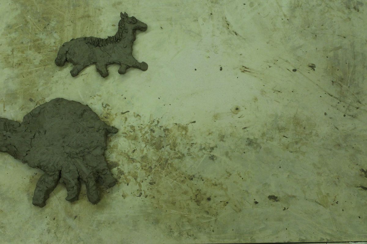 Animals of Prehistory in clay relief.
