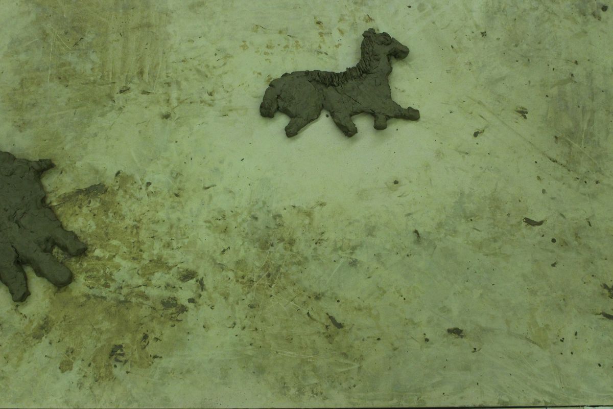 Animals of Prehistory in clay relief.