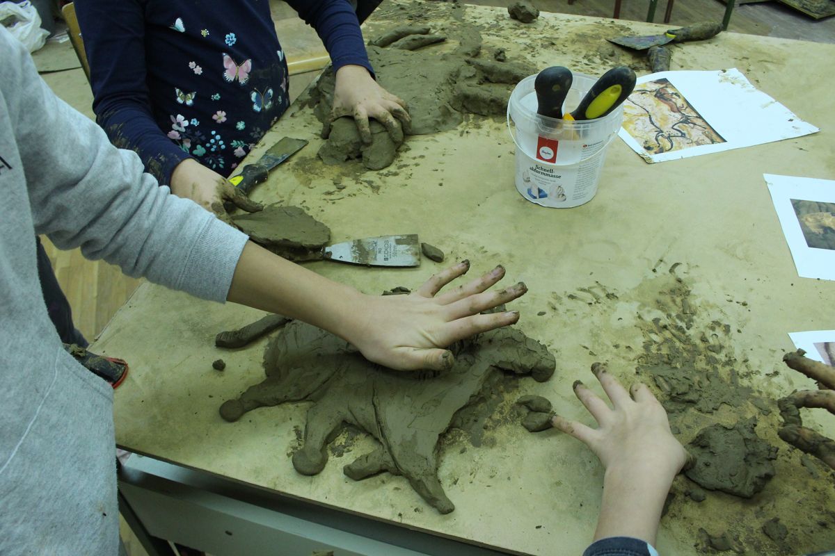 Animals of Prehistory in clay relief.