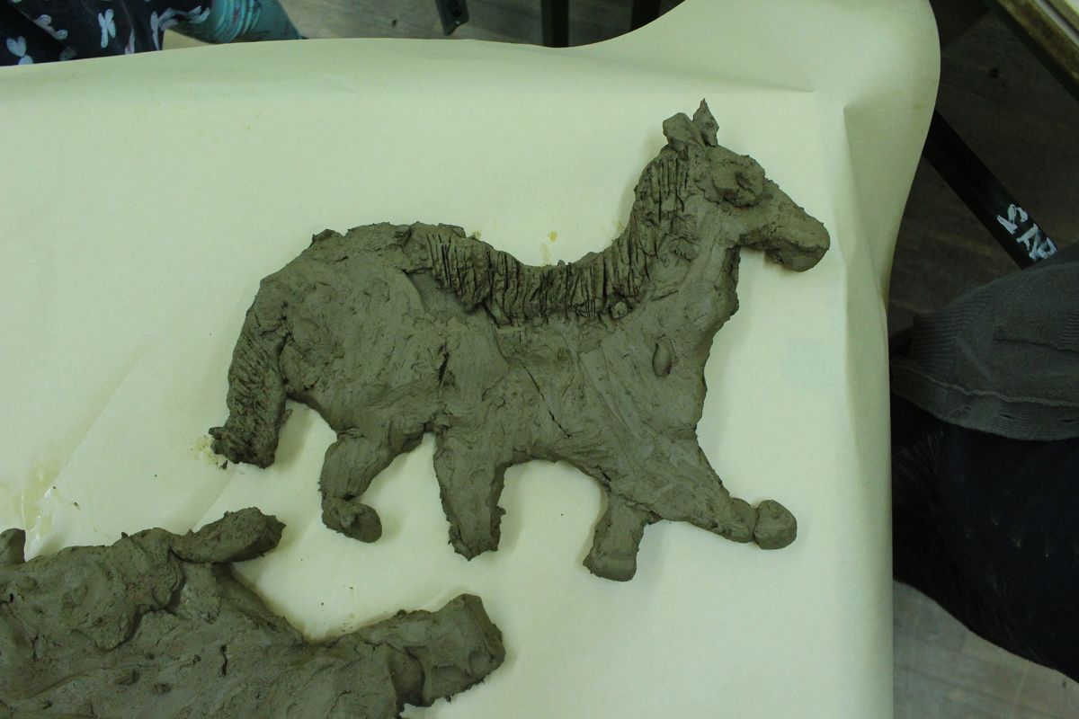 Animals of Prehistory in clay relief.