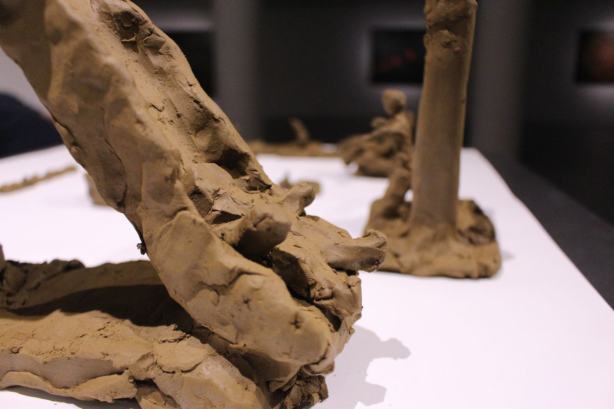 Children modeling playground in clay, close-up.